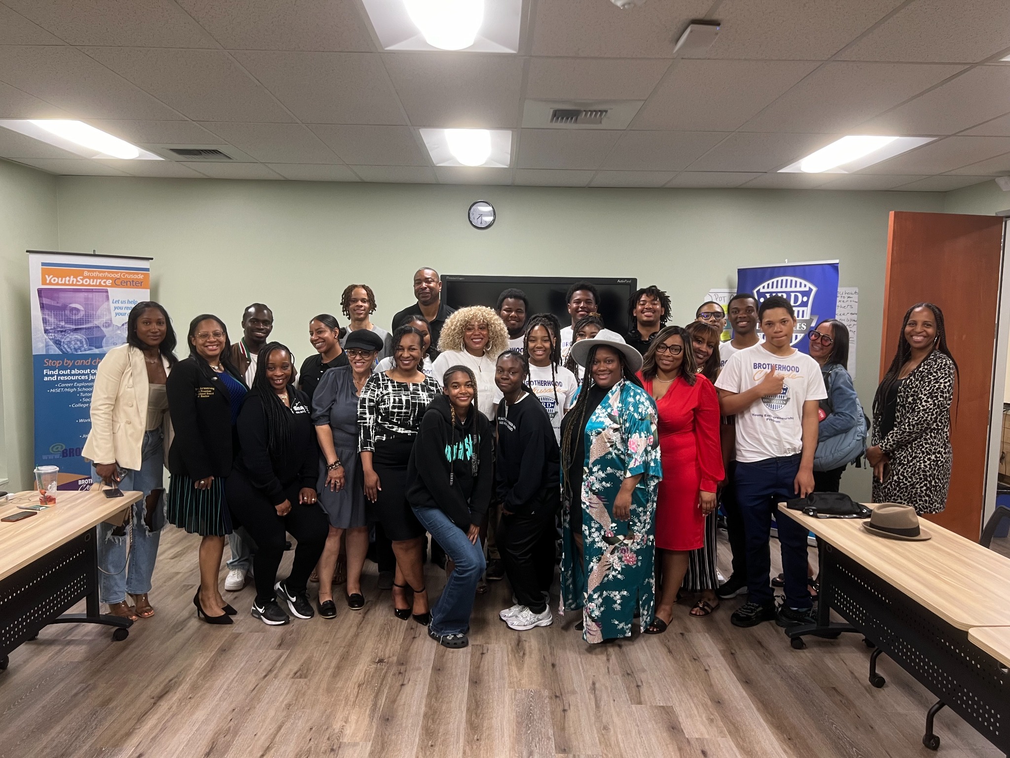 Young people and community leaders gathered in a classroom