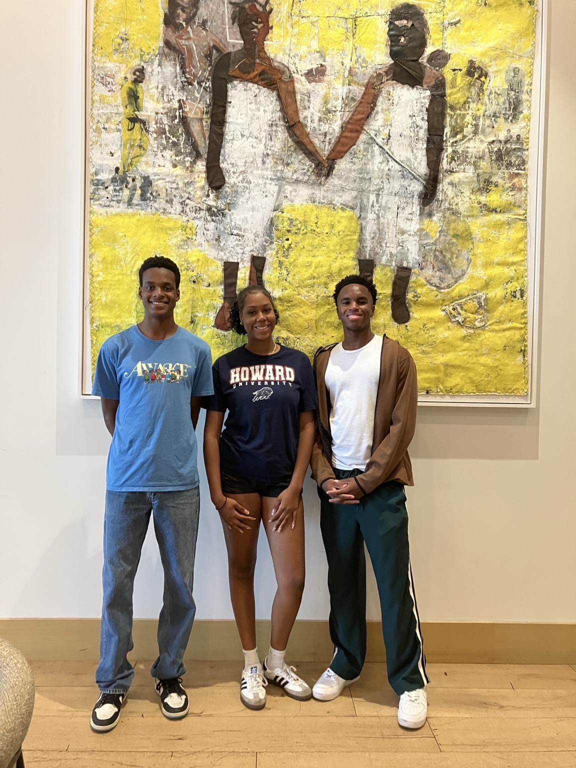 Three scholars visiting an art exhibition